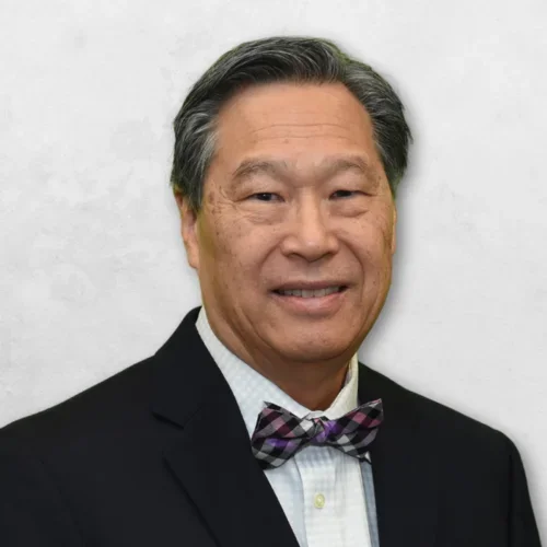 Dr. Chin is wearing a black blazer and bow tie