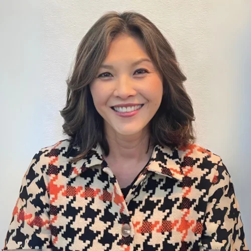 Dorothy Tu, smiling while wearing a pattered blouse