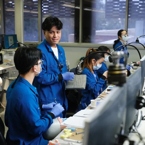 Two dental students conversing in a lab