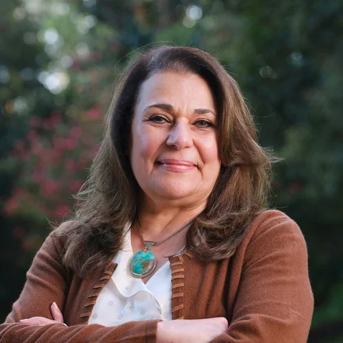 Dr. Fariba Younai, smiling with arms crossed
