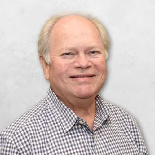 Dr. Mandell is wearing a dark brown and white checkered shirt.