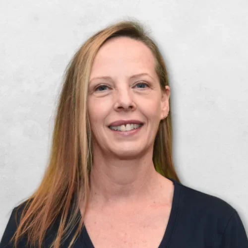 Geri Okamoto is wearing a black top and has long blonde hair.