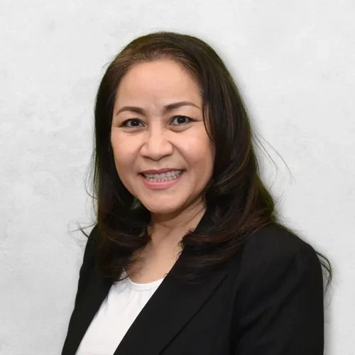 Hongnga Vo has long brown hair and is wearing a black blazer over a white shirt