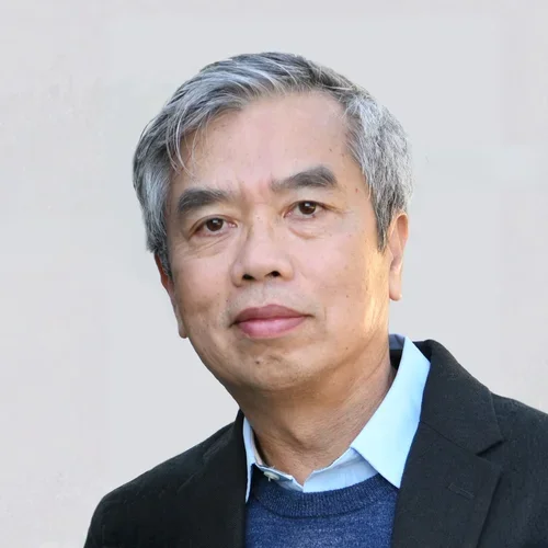 Dr. Hung Ton-That in a black blazer, against a gray background