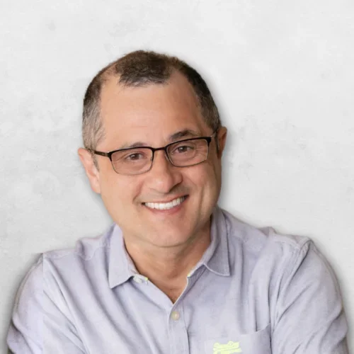 Luis Eduardo Martines is wearing a light blue shirt and has glasses.