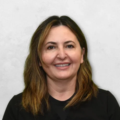 Dr. Parsangi is wearing a black top and has medium-length brown hair