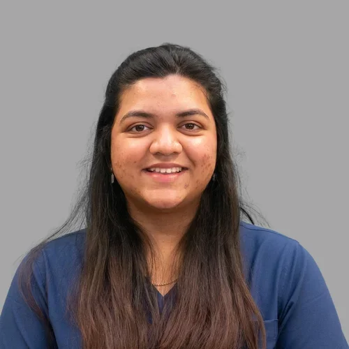 Rutuja Narkhede wearing blue medical scrubs against a gray background.