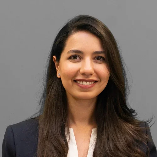 Dr. Samar Jalali is wearing a blazer over a white blouse.