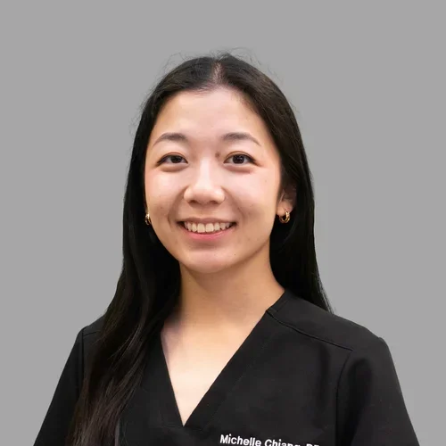 Dr. Michelle Chiang is dressed in black scrubs.