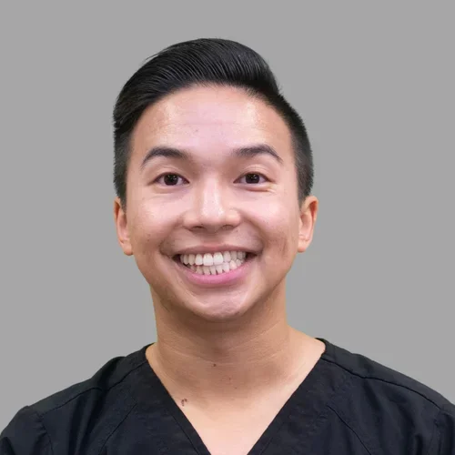 Dr. Matthew Nguyen is dressed in black medical scrubs.