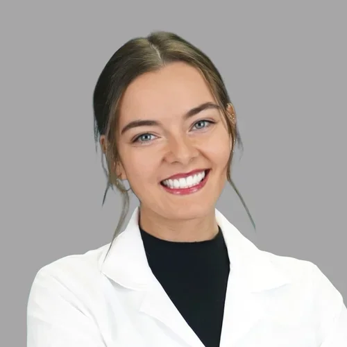 Maureen Bidsby smiling in a white lab coat with black shirt underneath