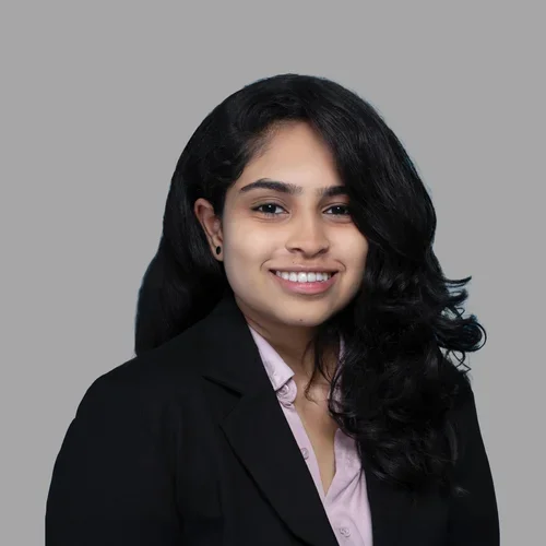 Dr. Geeta Bhuvanagiri is wearing a black blazer over soft lavender button-up shirt.