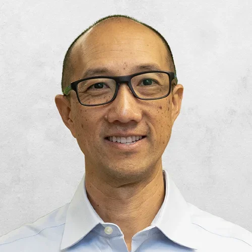 Dr. Chamkasem is wearing a light blue collar shirt.