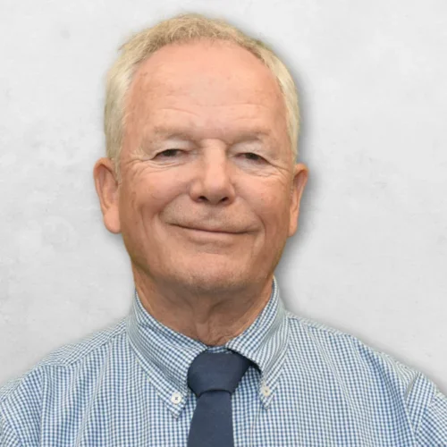 Dr. Duell is wearing a shirt and tie.