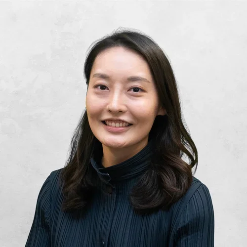 Sally Rhee is waring a dark blue blouse.