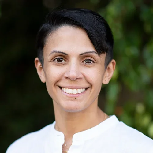 Shaded Al-Khalifah is wearing a white V-neck shirt.