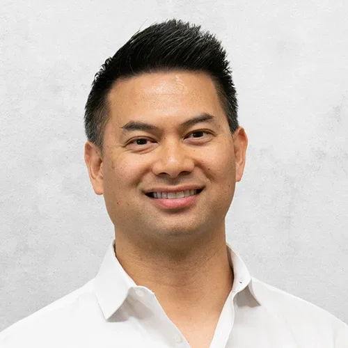 Dr. Arroyo is wearing a white button-up collared shirt.