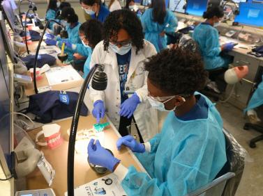 A student learns how to take alginate dental impressions