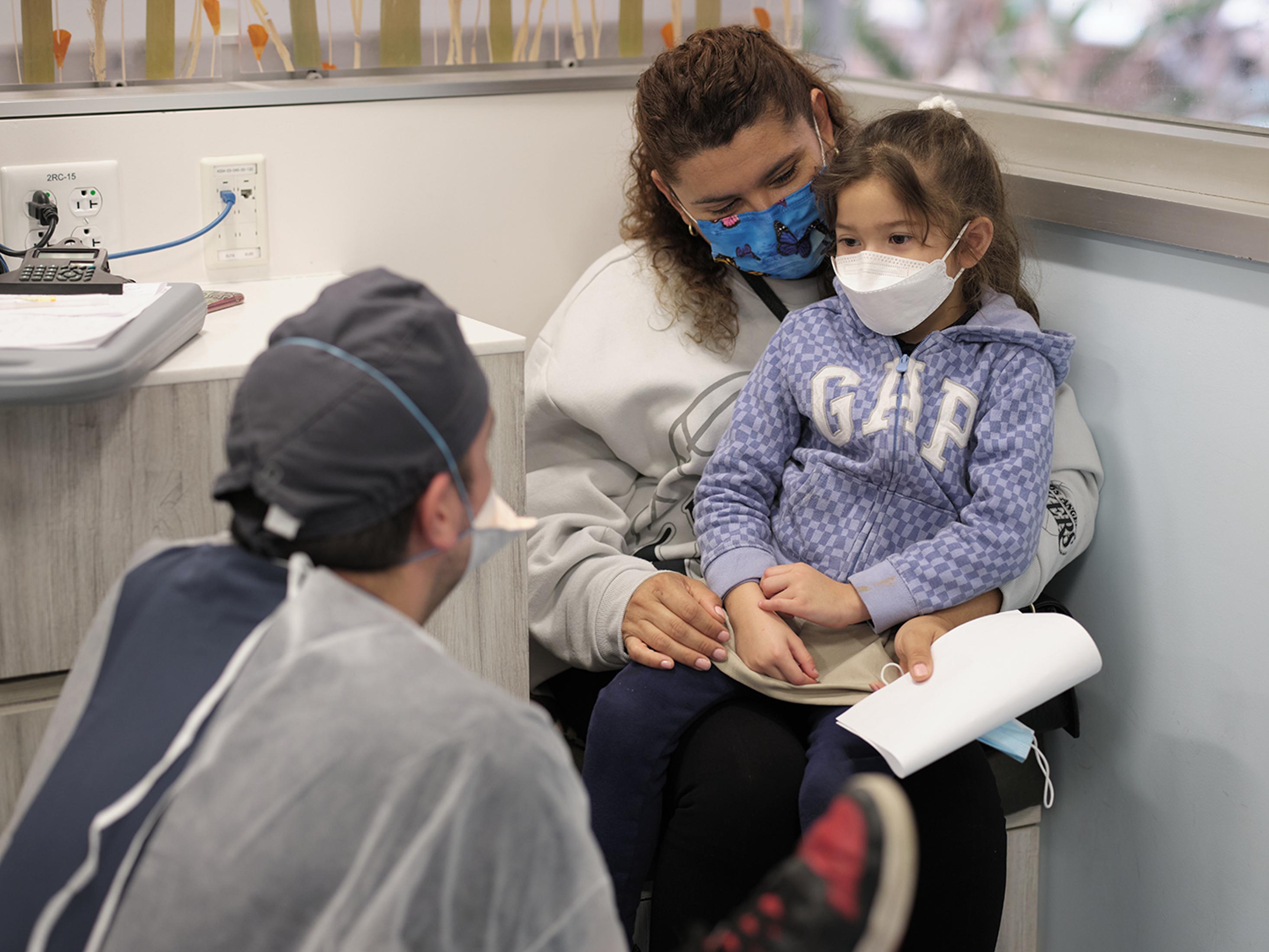 A pediatric resident talking to a patient.