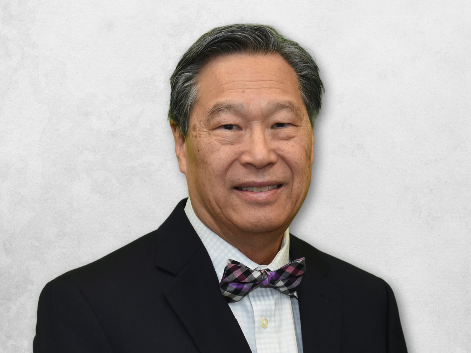 Dr. Chin is wearing a black blazer and bow tie
