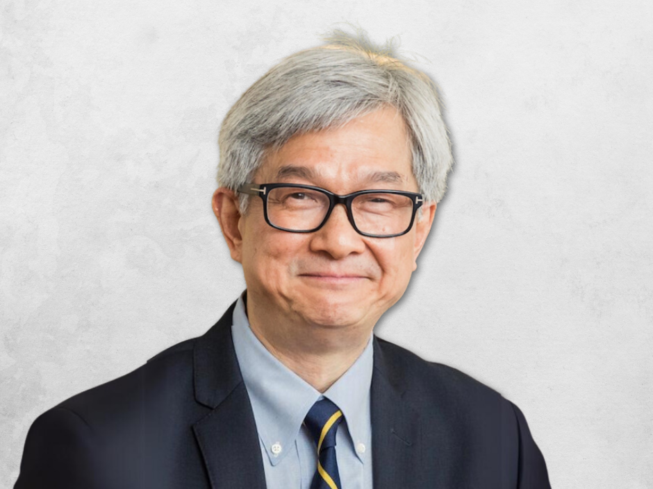 David T.W. Wong is wearing a suit and tie and glasses.