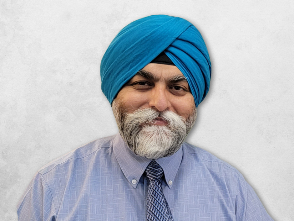 Kanwar Deep Singh Sachdeva is wearing a blue shirt with a tie and a light blue turban.