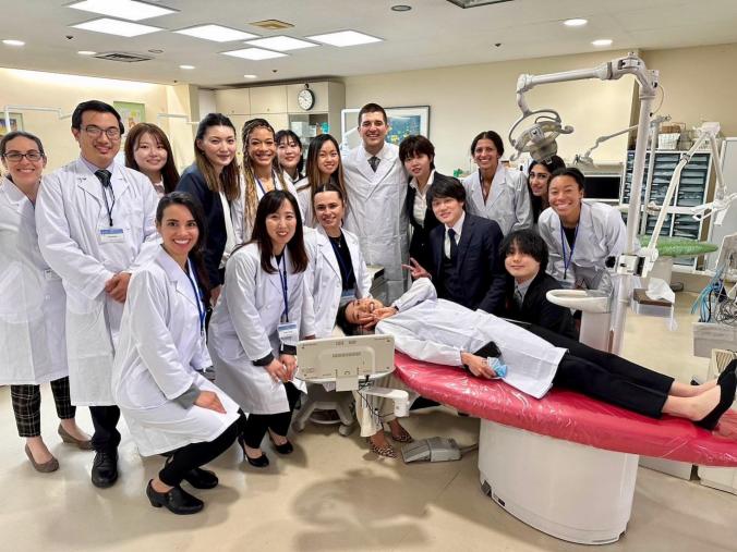Group in lab coats, posing in a dental clinic