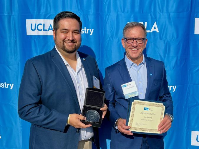 Dr. Mark Ortega and Dr. Paul Krebsbach pose against a blue backdrop