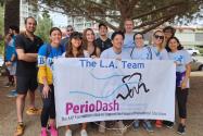 Runners in front of PerioDash Team LA sign