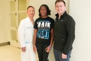 three people posing in a medical center