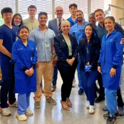 Group of people smiling in dental lab