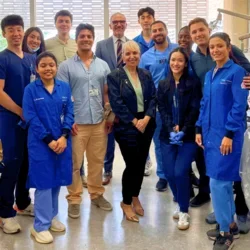 Group of people smiling in dental lab