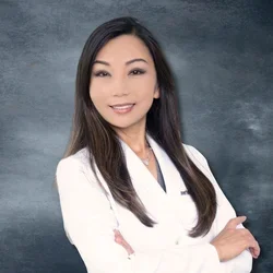 Dr. Katherine Ahn in white coat, representing clinical expertise and modern dental practice.