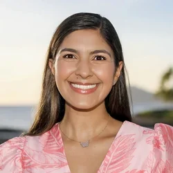 Ariana Kermani smiling outdoors at sunset