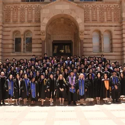 Group of 115 dental student graduates in commencement regalia