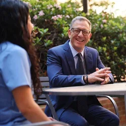 UCLA School of Dentistry Dean Paul Krebsbach speaking with dental students outdoors on campus, highlighting mentorship and leadership in dental education.