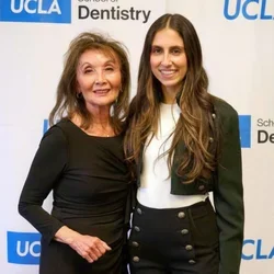 Oariona Lowe and Alliya Farahi posing at UCLA Dentistry event backdrop.