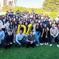 88 people posing on grass