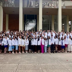 Group photo of dental students in white coats