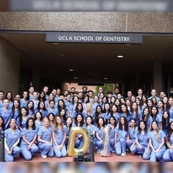 88 dental students in blue scrubs
