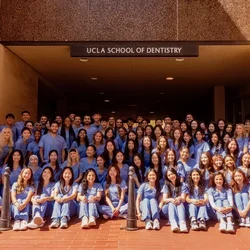 group of 88 dental students in blue scrubs