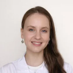 Iuliia smiling in a headshot