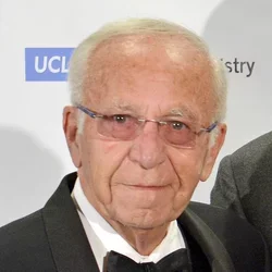 Dr. Henry Cherrick, wearing a tuxedo and glasses