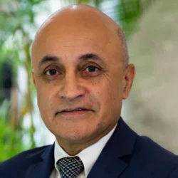 Dr. Kapila in suit and tie headshot