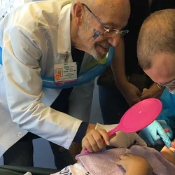 Dr. Philip Trask and pediatric resident with patient