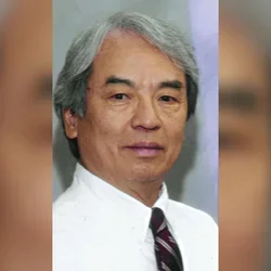 Dr. Thomson Sun wearing a white dress shirt and tie