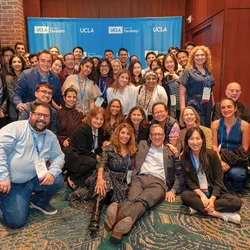 Large group of people in front of UCLA School of Dentistry sign