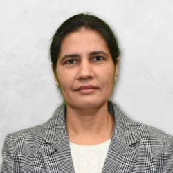 Dr. Shokeen is wearing a black and white blazer over a white top