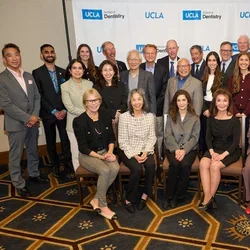 Large group of people in front of UCLA Dentistry backdrop
