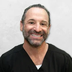 Dr. Bradley Matthew is wearing a black medical scrubs.